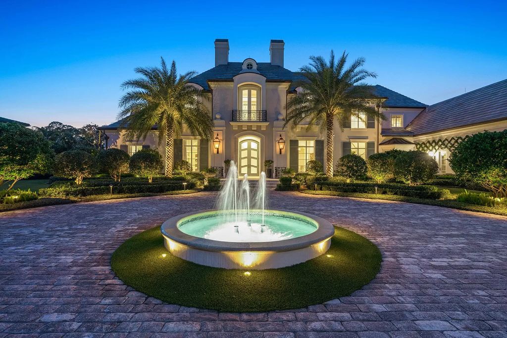 Discover European elegance at its finest within the prestigious Old Palm Golf Club at 12215 Tillinghast Cir, Palm Beach Gardens, Florida. This 1-acre estate boasts over 8,000 square feet, featuring five bedrooms, including a luxurious second-floor primary suite, two offices, a temperature-controlled wine room, elevator, attached guest house, and a four-car garage.