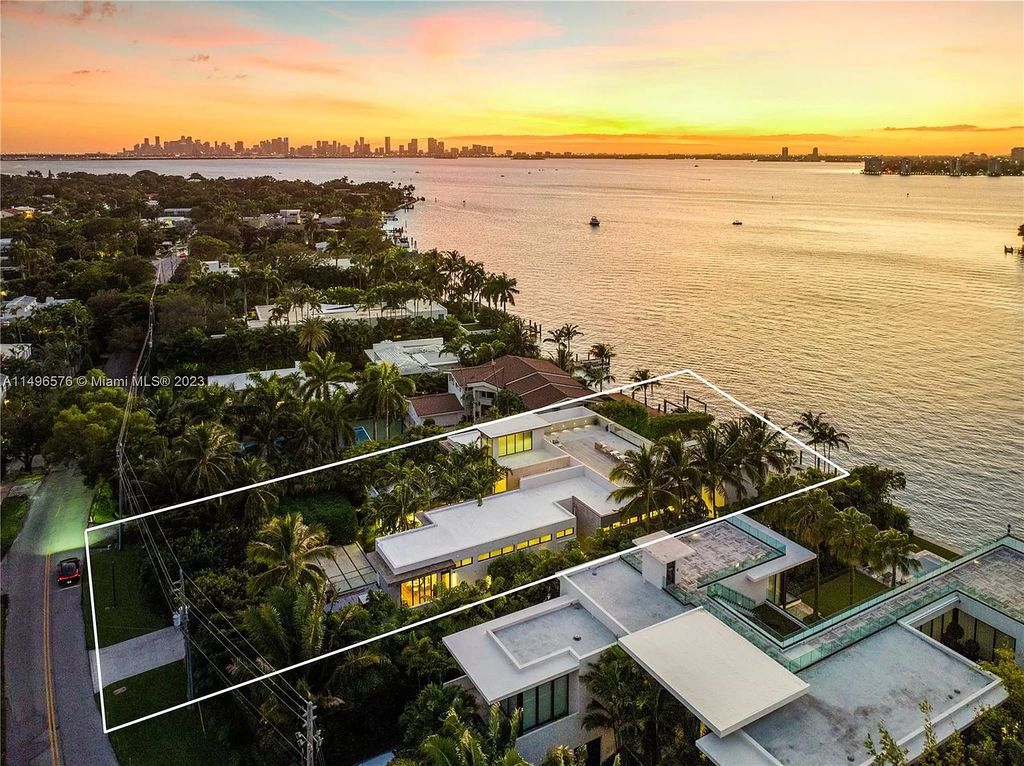 Nestled on prestigious North Bay Road, this 13,662 square feet waterfront masterpiece embodies tropical modernism at its finest. Designed by Choeff Levy Fischman, the home seamlessly merges indoor and outdoor living, boasting sliding glass walls, an airy atrium, and bayfront allure throughout.