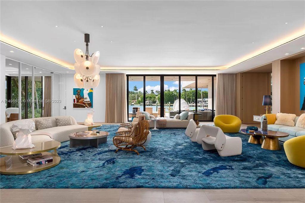 Nestled on prestigious North Bay Road, this 13,662 square feet waterfront masterpiece embodies tropical modernism at its finest. Designed by Choeff Levy Fischman, the home seamlessly merges indoor and outdoor living, boasting sliding glass walls, an airy atrium, and bayfront allure throughout.
