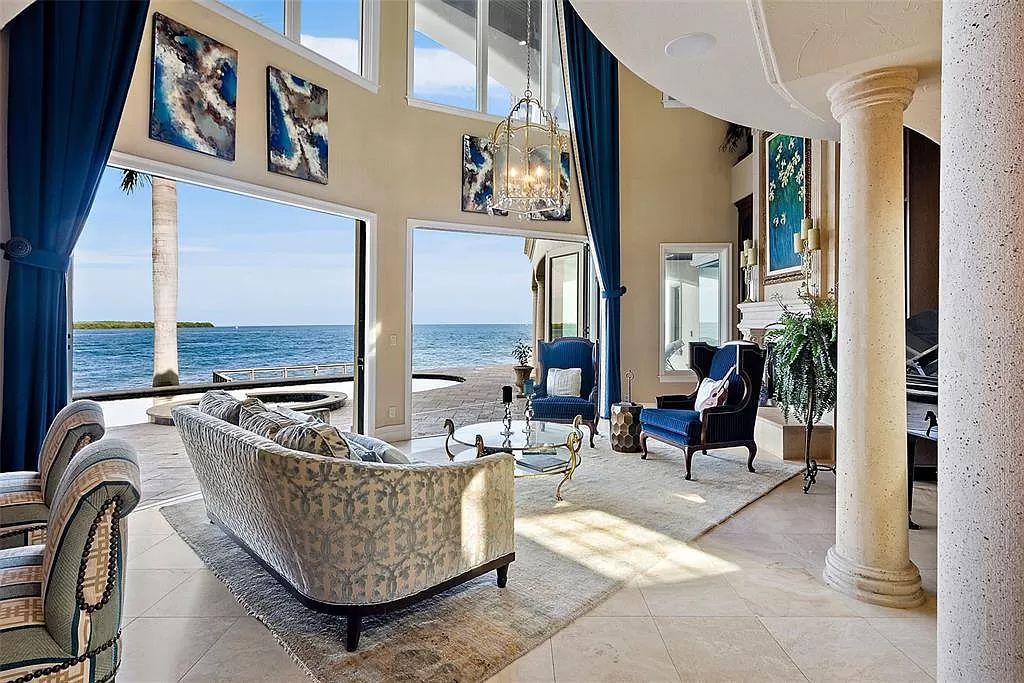 This 2014 waterfront marvel by Campagna Homes offers the pinnacle of luxury living across two lots with direct Tampa Bay access. Boasting 5 bedrooms, 6.5 baths, and versatile spaces including an office, gym, and game room with a wet bar, this 7,841-square-foot masterpiece features a gourmet kitchen, Swarovski crystal-adorned dining room, and a gas fireplace-lit living room.