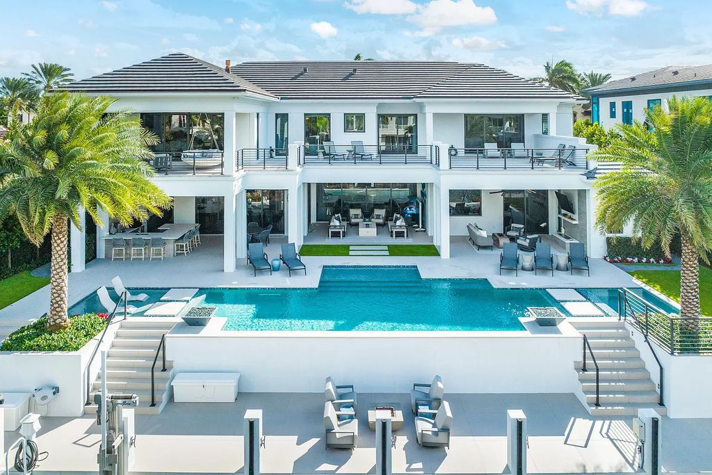 Discover unparalleled luxury along 100 feet of the Butterfly Palm Waterway in this prestigious 5-bedroom SRD Building Corp. masterpiece. Meticulously curated for the discerning homeowner, the resort-grade backyard with a zero-edge pool, spa, and enchanting fire bowls invites seamless indoor-outdoor living.