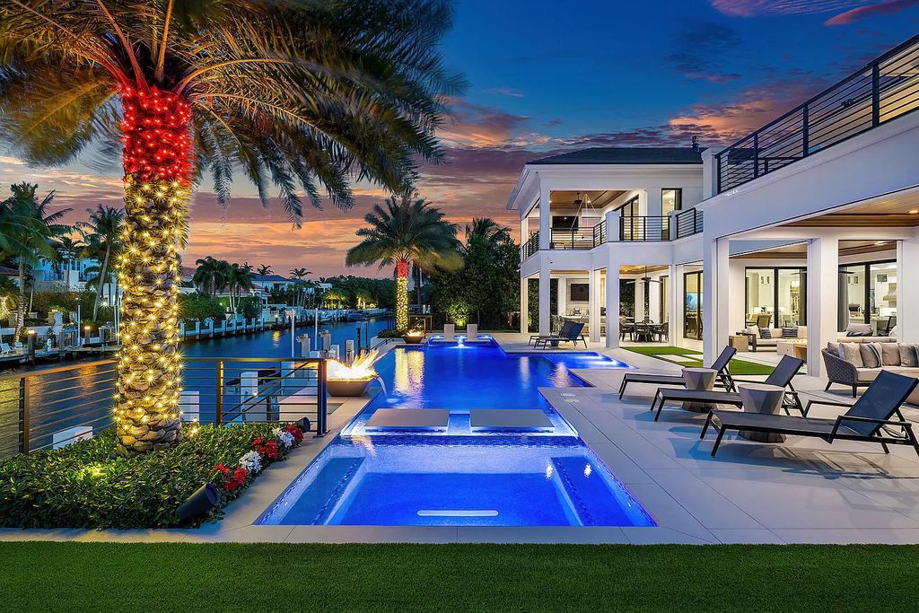 Discover unparalleled luxury along 100 feet of the Butterfly Palm Waterway in this prestigious 5-bedroom SRD Building Corp. masterpiece. Meticulously curated for the discerning homeowner, the resort-grade backyard with a zero-edge pool, spa, and enchanting fire bowls invites seamless indoor-outdoor living.