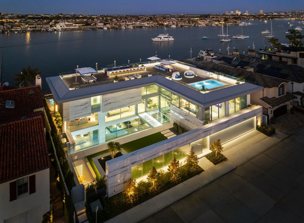 1220 W Bay Avenue Home in Newport Beach, California. Explore the epitome of opulence in this newly constructed waterfront luxury estate with breathtaking Bay views. Crafted by renowned architect Paul McClean and masterfully brought to life by Gallo Builders, this 6-bedroom, 8-bathroom residence spanning over 12,700 square feet is a harmonious blend of modern sophistication and unparalleled craftsmanship.