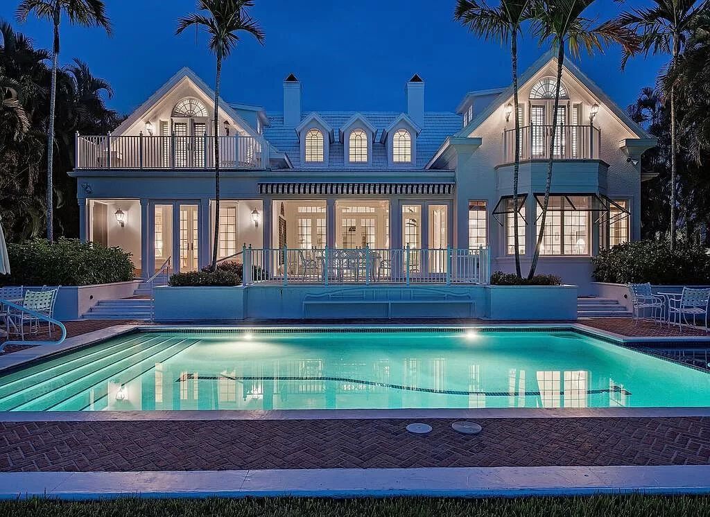 Nestled at 1300 Spyglass Lane in Naples, Florida, this remarkable property presents an exquisite fusion of Bermuda-style architecture and Cape Cod allure.