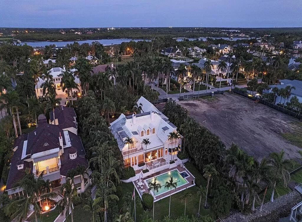 Nestled at 1300 Spyglass Lane in Naples, Florida, this remarkable property presents an exquisite fusion of Bermuda-style architecture and Cape Cod allure.