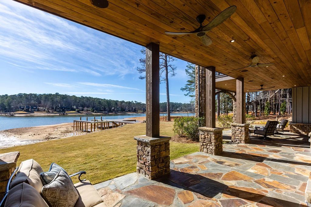 1583 Bulgers Mill Way Home in Alexander City, Alabama. Explore the epitome of lake living in this custom-built 5BR/5.5BA home located within The Willows of Willow Point on Lake Martin. Designed by renowned architect Mitch Ginn, this 2020 gem offers sun-soaked southern views, a 32' boat slip, and high-end furnishings by Mathison Interiors. 