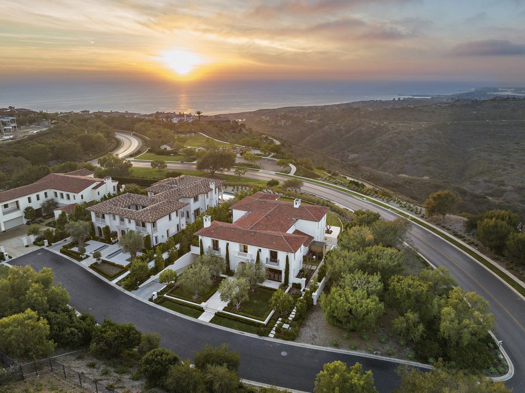21 Spinnaker Home in Newport Coast, California. Discover luxury living at its finest in this stunning 11,700 sq. ft. estate in Crystal Cove. Completed in 2020, this meticulously designed residence offers unobstructed ocean and coastline views, dual master suites, a chef's kitchen, home theater, gym, and more. 