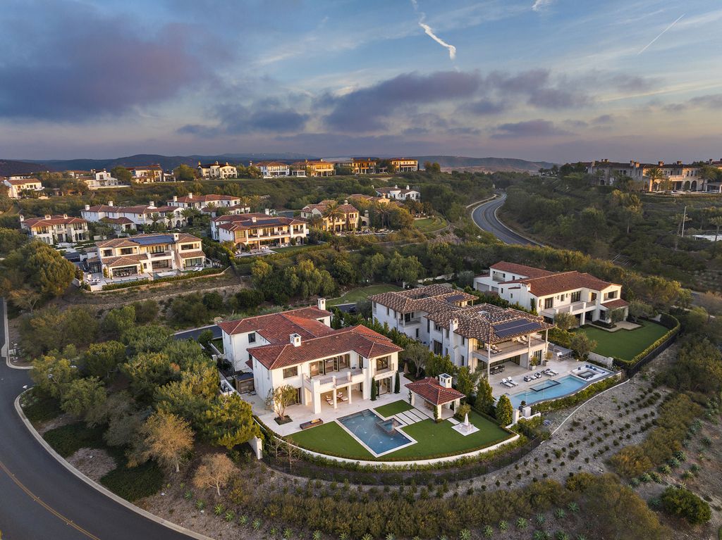 21 Spinnaker Home in Newport Coast, California. Discover luxury living at its finest in this stunning 11,700 sq. ft. estate in Crystal Cove. Completed in 2020, this meticulously designed residence offers unobstructed ocean and coastline views, dual master suites, a chef's kitchen, home theater, gym, and more. 