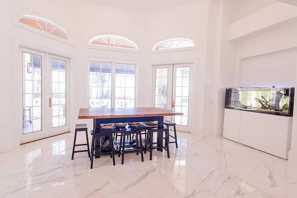 Nestled in the prestigious guard-gated Cypress Point community, this exceptional 6-bedroom, 9-bathroom estate at 9220 Point Cypress Dr, Orlando, Florida 32836 offers a rare glimpse of luxurious living.