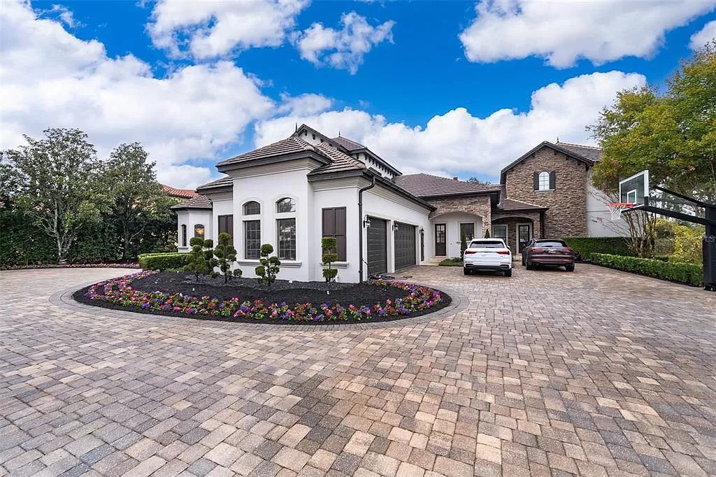 Nestled on a sprawling lot just under 3 acres in Windermere, FL, 9313 Tibet Pointe Cir is a fully remodeled Keen’s Pointe Villa that epitomizes luxury living and privacy. Boasting 6 beds, 8 baths, and 8,792 square feet of living space, this Orlando villa offers a serene lakeside retreat with a salt-water pool, private boat dock on Lake Tibet, and a vast backyard.