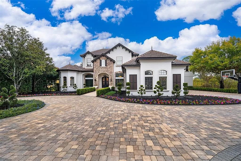Nestled on a sprawling lot just under 3 acres in Windermere, FL, 9313 Tibet Pointe Cir is a fully remodeled Keen’s Pointe Villa that epitomizes luxury living and privacy. Boasting 6 beds, 8 baths, and 8,792 square feet of living space, this Orlando villa offers a serene lakeside retreat with a salt-water pool, private boat dock on Lake Tibet, and a vast backyard.