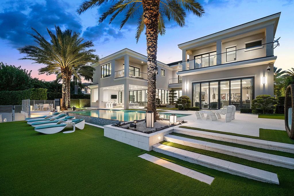 Discover an unparalleled waterfront oasis at 290 South Maya Palm Drive, a breathtaking 5-bedroom, 6.2-bathroom estate by Bloomfield Construction.