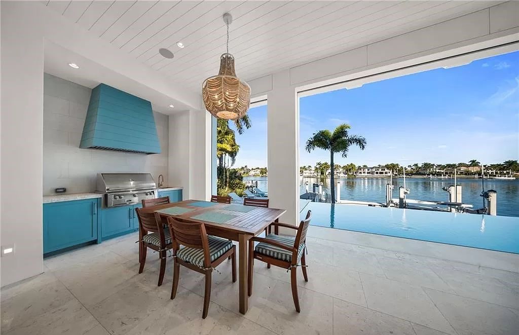 This Port Royal gem on Treasure Cove's western shore boasts unmatched panoramic water views. Crafted by D.Garrett Construction and Stofft Cooney Architects, it seamlessly blends indoor and outdoor living, featuring an infinity-edge pool mirroring the nearby beach.