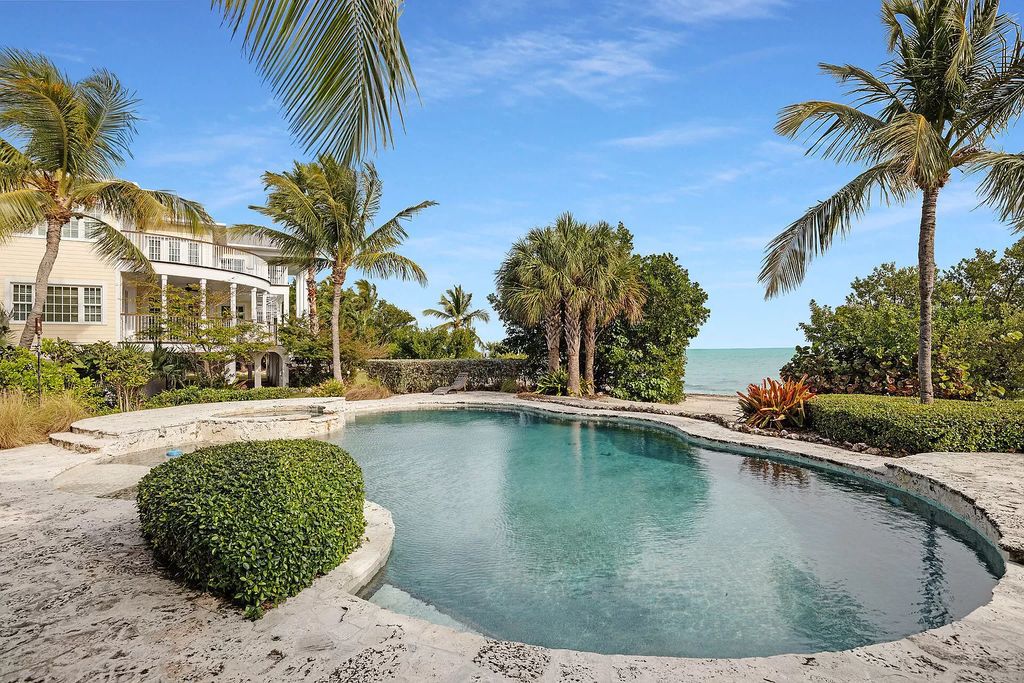 Experience the epitome of luxury island living at this exquisite Luxury Oceanfront Estate in Islamorada. Nestled on 10.85 acres along the Atlantic Ocean, this 2006-built property offers 450 feet of pristine beachfront accessed through a private, gated entrance.