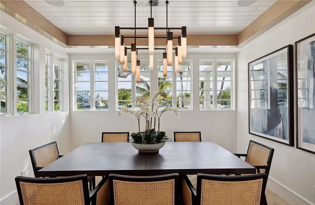 Step into timeless luxury at 239 Broad Ave S, an impeccably redesigned Olde Naples cottage by MHK Architecture. This 4-bedroom, 6-bathroom residence, just steps from the beach, seamlessly marries the charm of a 1940's home with modern sophistication.