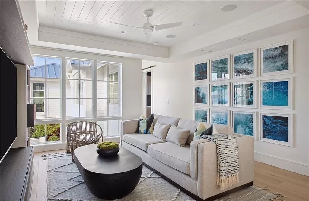 Step into timeless luxury at 239 Broad Ave S, an impeccably redesigned Olde Naples cottage by MHK Architecture. This 4-bedroom, 6-bathroom residence, just steps from the beach, seamlessly marries the charm of a 1940's home with modern sophistication.