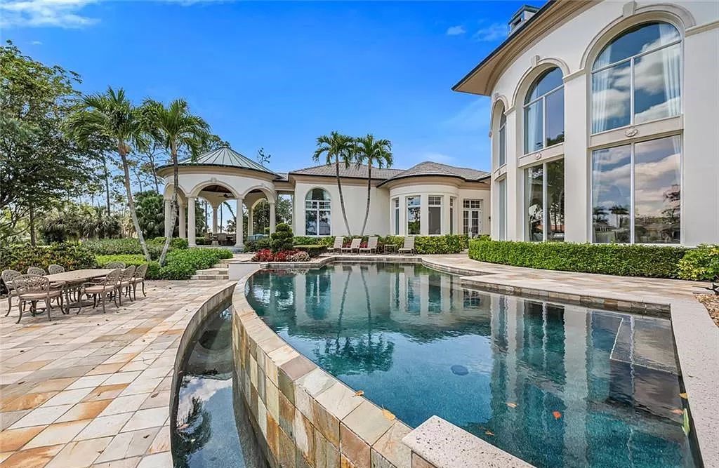 Discover unparalleled luxury at 6548 Highcroft Dr, Naples, FL 34119 - a custom-built estate by London Bay, designed by Stofft Cooney Architects. This 5-bedroom, 6-bathroom residence spans 7,028 square feet of living space on a 1.32-acre lot with immediate golf access.