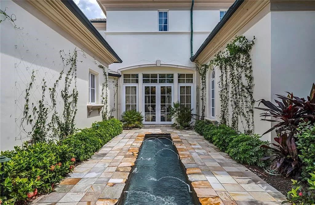 Discover unparalleled luxury at 6548 Highcroft Dr, Naples, FL 34119 - a custom-built estate by London Bay, designed by Stofft Cooney Architects. This 5-bedroom, 6-bathroom residence spans 7,028 square feet of living space on a 1.32-acre lot with immediate golf access.
