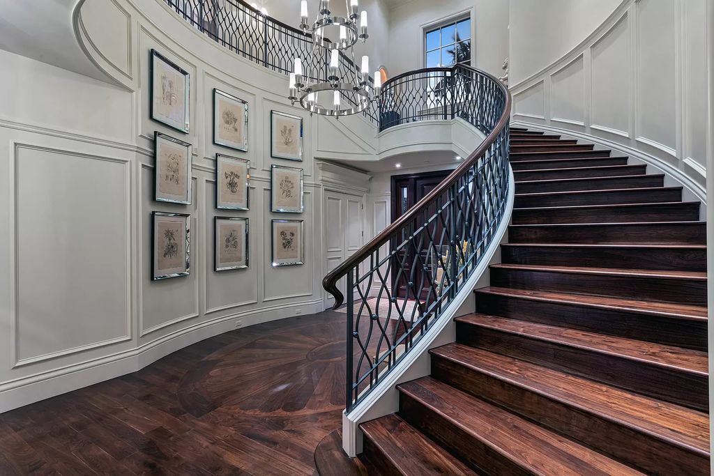 Crafted by Frankel Estate Homes, designed by Carlos Martin Architects, and styled by Marc-Michaels, this 6-bedroom, 10-bathroom mansion showcases an elegant staircase, grand salon, modern kitchen, and a lavish primary suite with waterfront vistas.