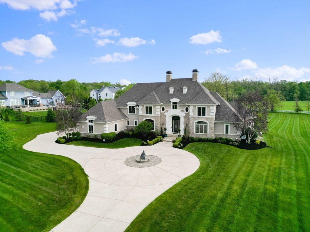 1840 Woodland Hall Drive Home in Delaware, Ohio. Discover luxury living in this regal stone and stucco estate nestled on 2.15 private acres in Woodland Hall. Boasting impeccable craftsmanship and quality, this builder's own residence features an open floor plan, high ceilings, and abundant natural light. 