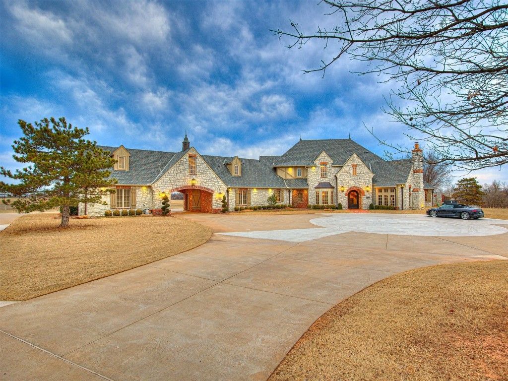 19700 N Macarthur Boulevard Home in Edmond, Oklahoma. Discover the epitome of luxury living on this breathtaking 80-acre Deer Creek estate, complete with equestrian facilities, a serene 3-acre pond, and a remodeled house boasting full guest quarters. 