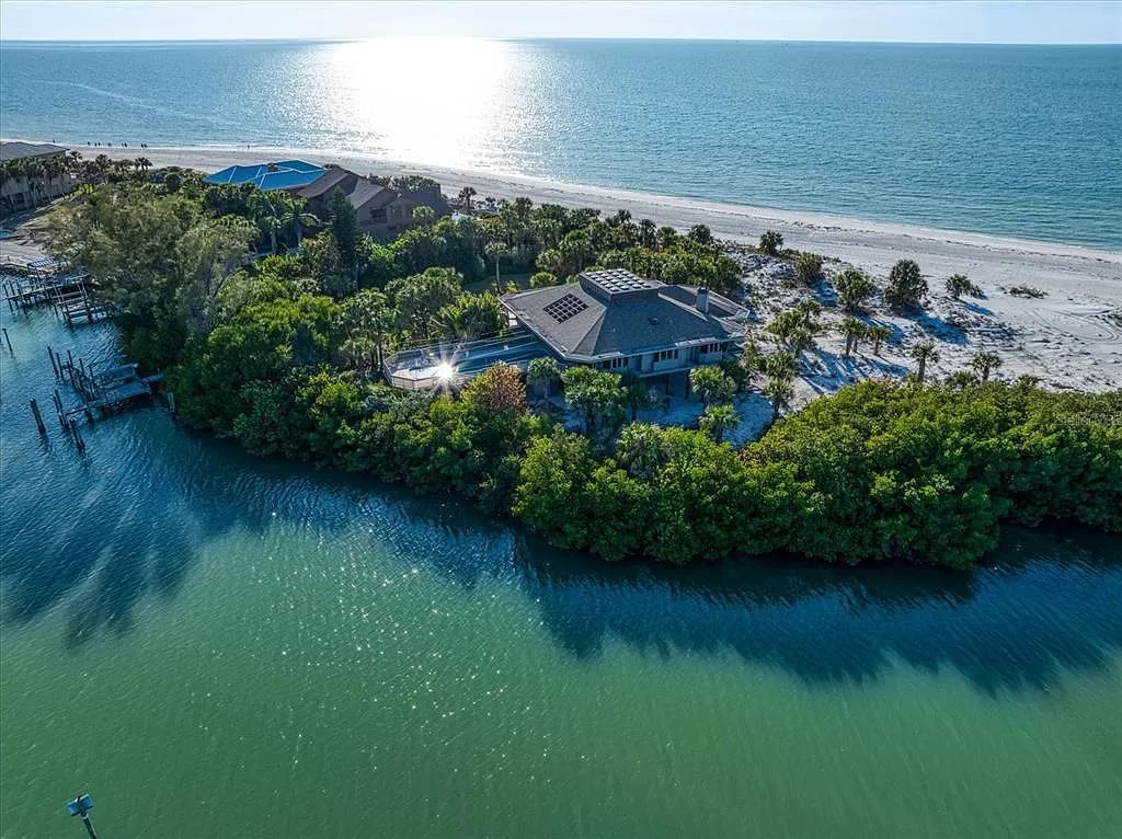 Welcome to 1198 Mandalay Point, a secluded oasis offering unparalleled luxury amidst the natural beauty of Clearwater Beach.
