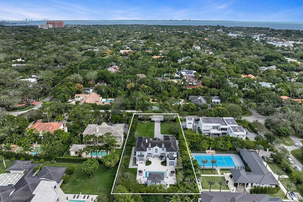 Welcome to an exceptional Ponce-Davis estate boasting meticulous design and luxurious living. From its stunning architectural facade to the custom interiors featuring herringbone hardwood and marble flooring, every detail of this residence exudes elegance.