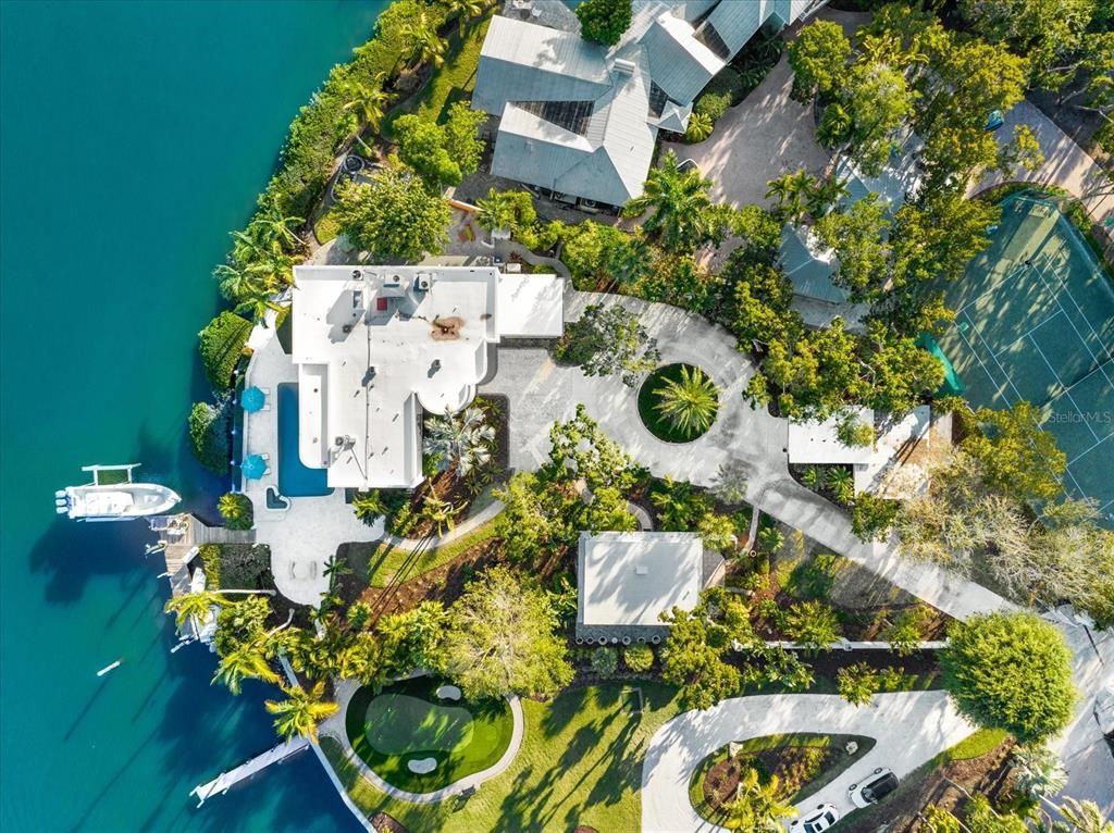 Nestled along the serene shores of Cocoanut Bayou, this captivating 4-bedroom, 4-bathroom sanctuary offers an unparalleled lifestyle for sailboat enthusiasts, boasting two boat lifts and panoramic water views.