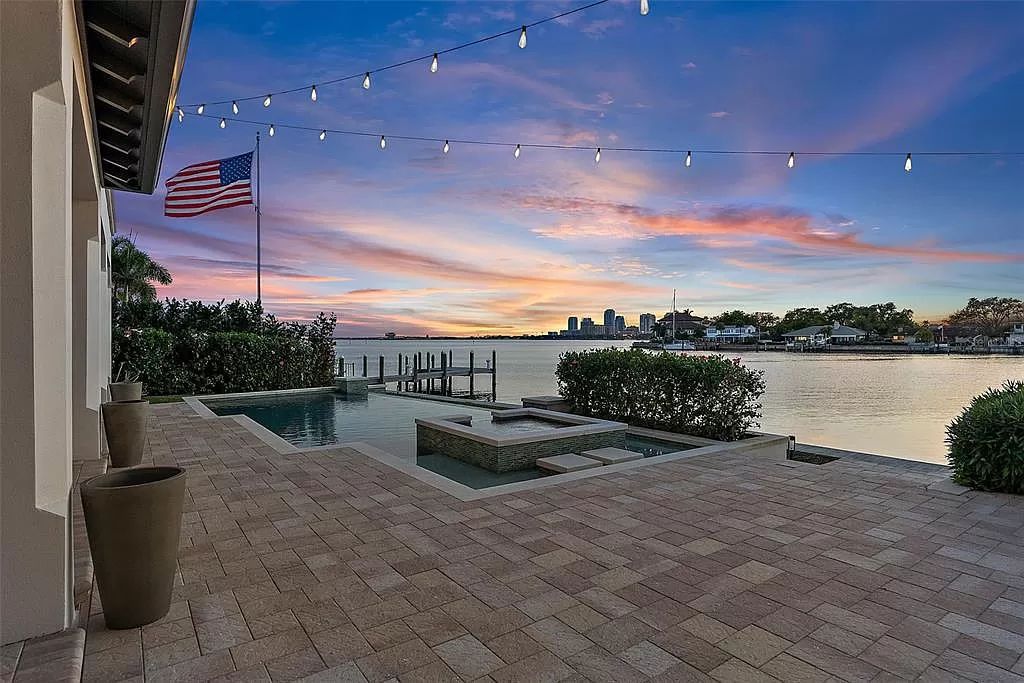 Indulge in the pinnacle of waterfront luxury living at 117 Bay Point Dr NE, Saint Petersburg, FL 33704. This exquisite property, nestled within the exclusive island enclave of Snell Isle, offers captivating ocean views from nearly every room, ensuring privacy and exclusivity among only 30 other houses.