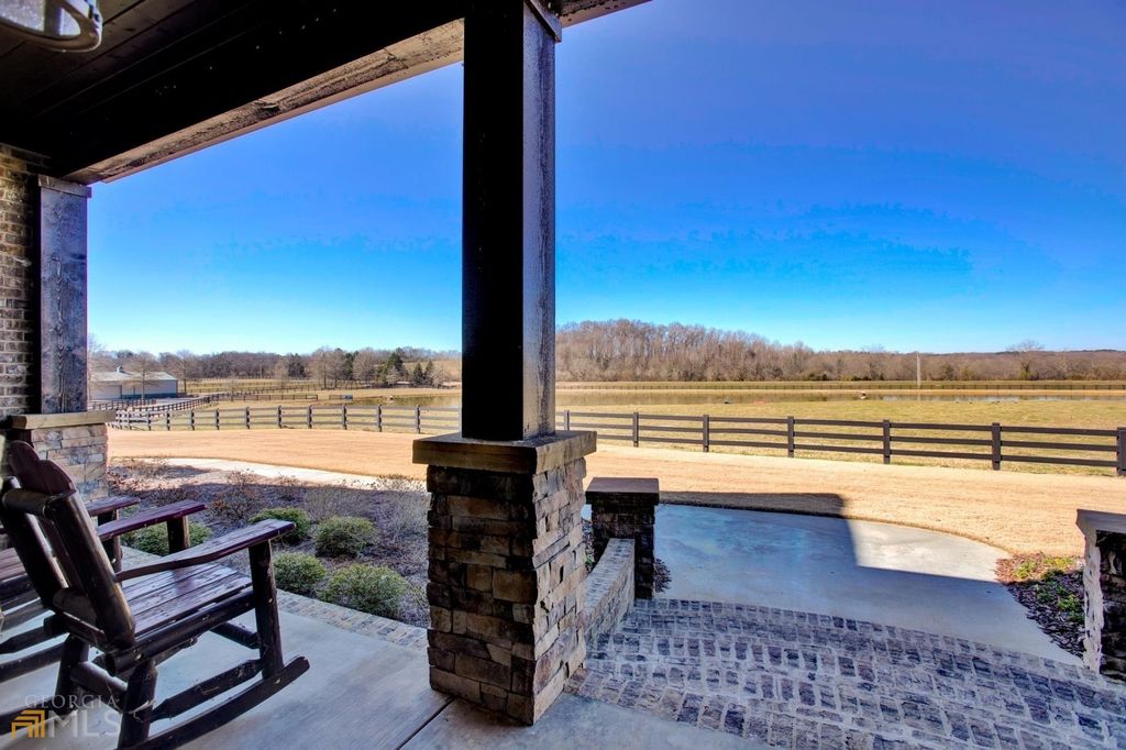 1211 Owens Gin Road NE Home in Calhoun, Georgia. Explore the beauty of this 39.55-acre farm nestled in Northwest Georgia, featuring a stunning home overlooking a stocked lake and the Coosawattee River.