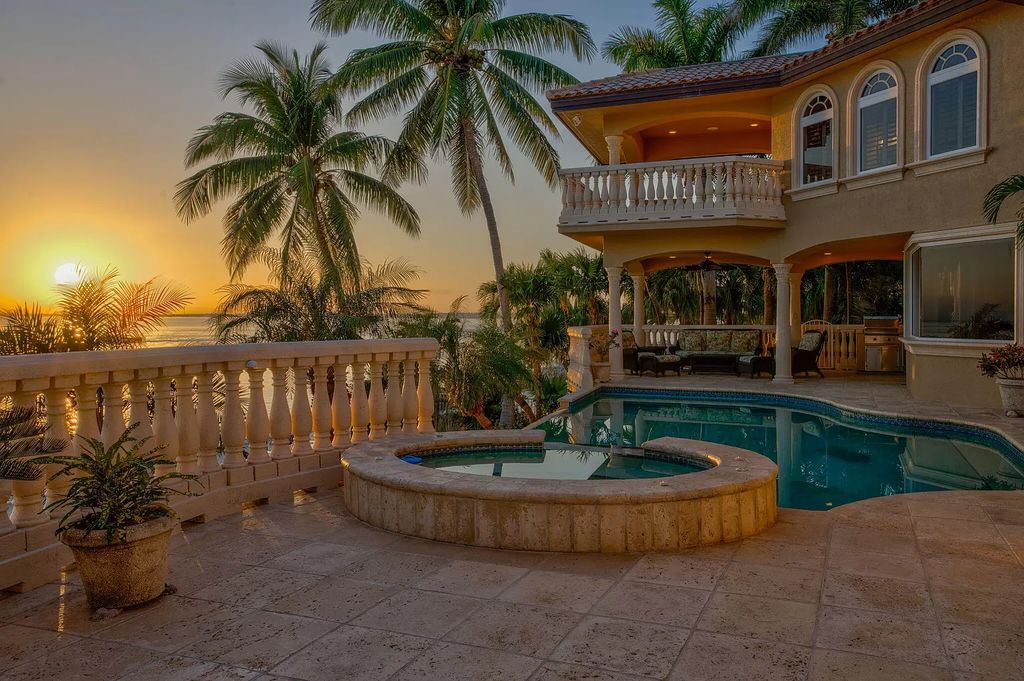 Welcome to The Sandcastle in Key Colony Beach, where luxury meets coastal living. This custom D'Asign Source home boasts unparalleled open water views, set on an immaculate gated double lot with a private sandy beach and lush landscaping.