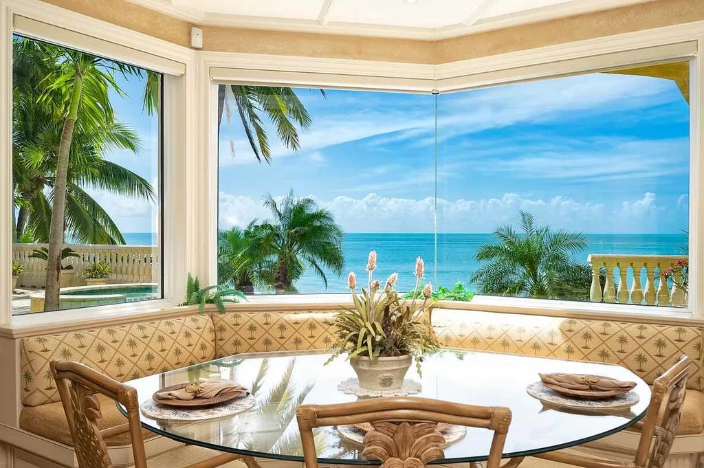 Welcome to The Sandcastle in Key Colony Beach, where luxury meets coastal living. This custom D'Asign Source home boasts unparalleled open water views, set on an immaculate gated double lot with a private sandy beach and lush landscaping.