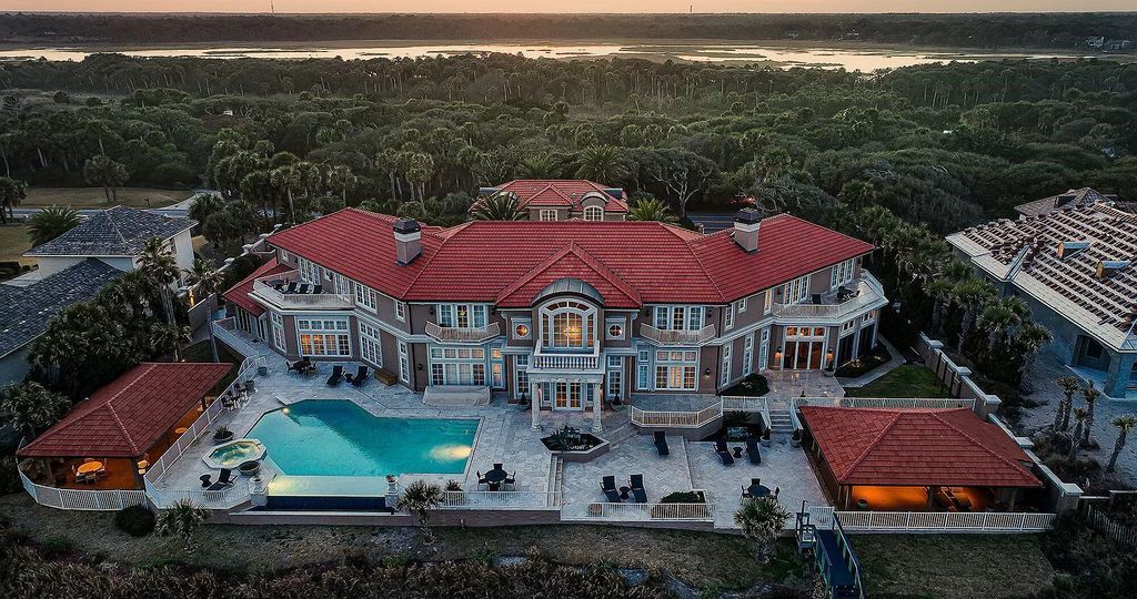 With 30' elevations, this opulent residence offers resort-style amenities for luxurious entertaining, including a gourmet kitchen, dine-in wine cellar, grand dining room, and a first-floor owner's wing with office, library, and outdoor living space.