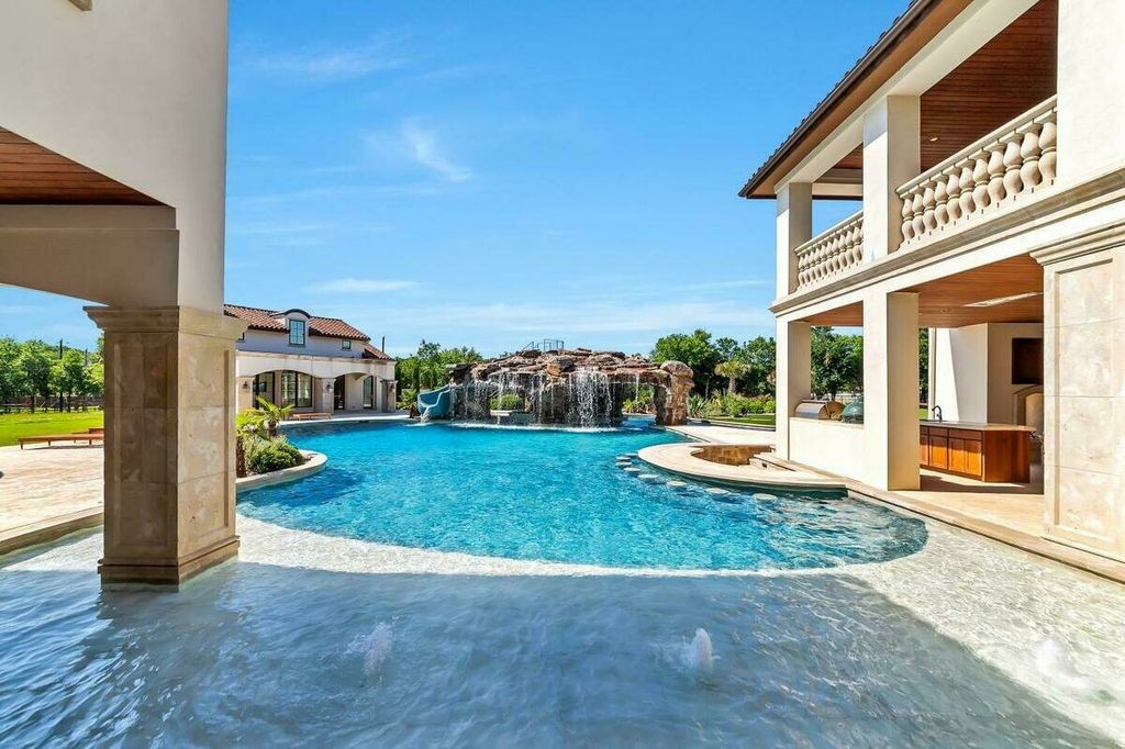 1800 Florence Road Home in Keller, Texas. Step into luxury at this sprawling 7-bedroom estate nestled on 10 acres with a serene pond. From the grand entrance with custom chandeliers to the resort-inspired backyard featuring a lazy river, grotto, and swim-up bar, every detail exudes opulence.