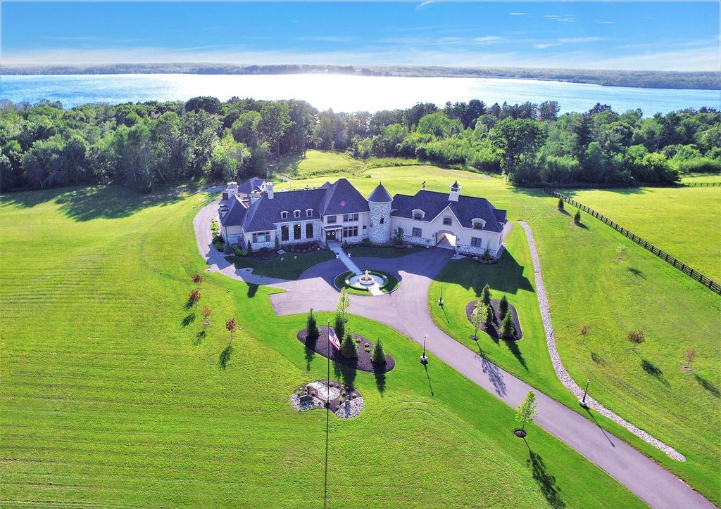 65 Brown Road Home in Stillwater, New York. Experience unparalleled luxury in this exquisite French Country Chateau nestled on 15 acres with stunning views of Saratoga Lake. Boasting 7,237 SF, this custom mansion features 5 bedroom suites, 7.5 baths, and a separate pool house with kitchenette, bathroom, and fireplace. 