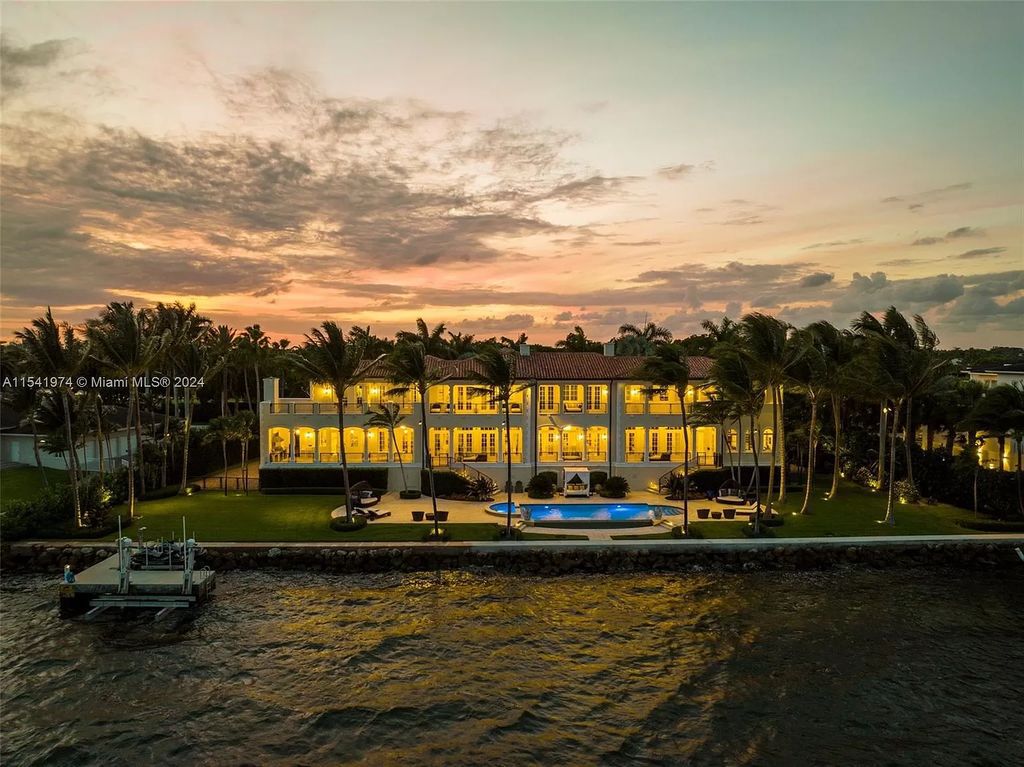Nestled within the prestigious guard-gated community of Gables Estates, 33 Arvida Parkway presents a magnificent 14,972-square-foot estate boasting 225 feet of waterfront on a lushly landscaped 35,389-square-foot lot.