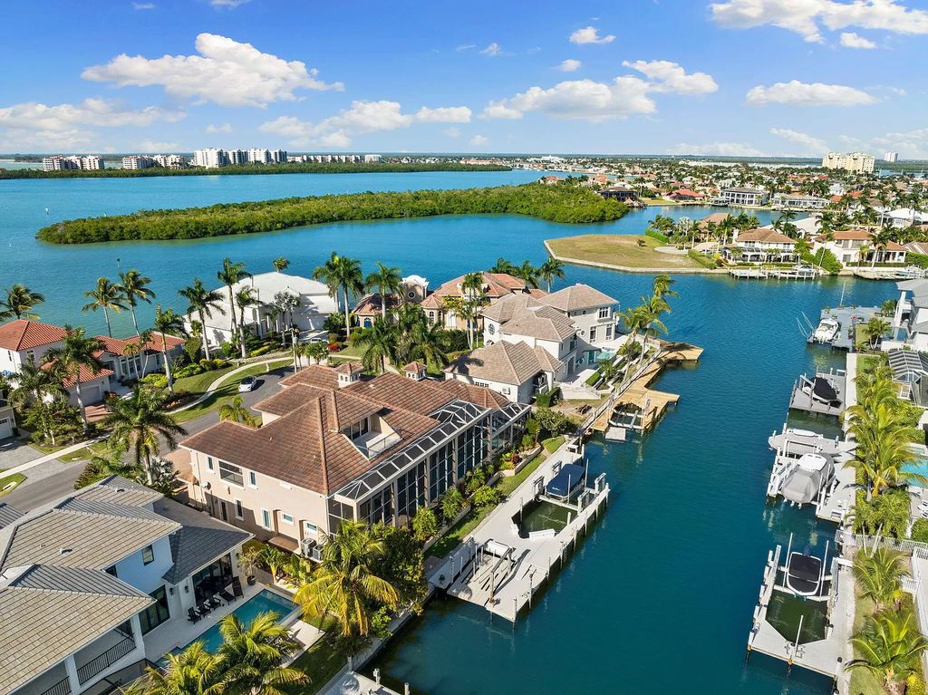 Experience unparalleled luxury living at this waterfront estate in Tigertail/Collier Bay, Marco Island. Boasting over $400,000 in price reduction, this multi-level home features a private elevator, 6 bedrooms, 7 bathrooms, 2 living rooms, a den, and a formal dining room, spanning just over 6,500 square feet of living space.