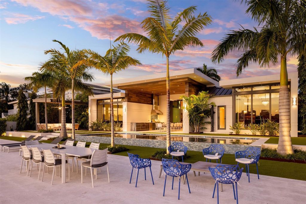 Rebuilt in July 2023, this single-story smart home offers 5,073 square feet of sophisticated living space on a sprawling 15,300-square-foot lot with a 2,300-square-foot dock adorned with coral stone from Spain.