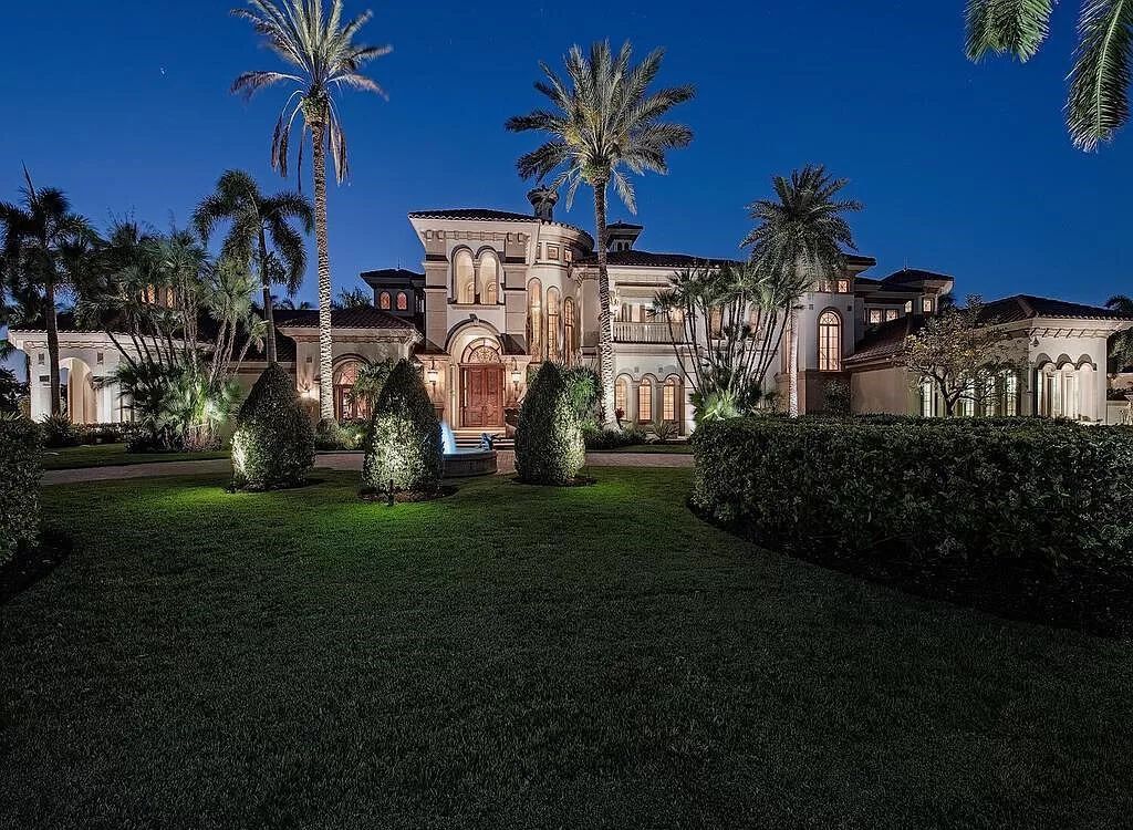 Discover unparalleled luxury living in the prestigious Estates at Bay Colony with this exquisite European-inspired residence nestled on a double lakefront estate.