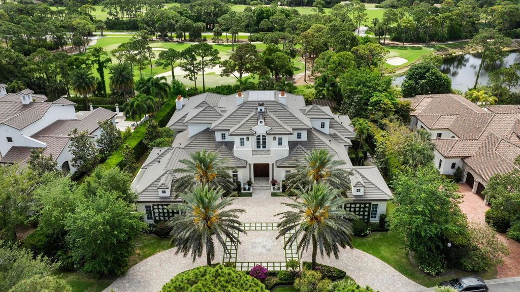 Welcome to 131 W Bears Club Drive, an exclusive retreat in Jupiter's prestigious golf community. This custom-built estate, one of only 48 in the enclave, offers over 12,000 square feet of luxury living on nearly 0.6 acres.