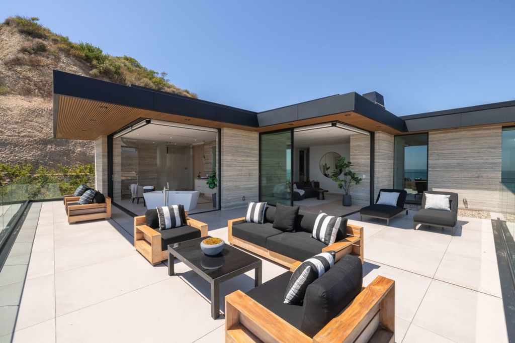 23917 Malibu Road Home in Malibu, California. Experience luxury coastal living in this contemporary masterpiece by architect Doug Burdge, located in the private and gated Malibu Colony Estates.