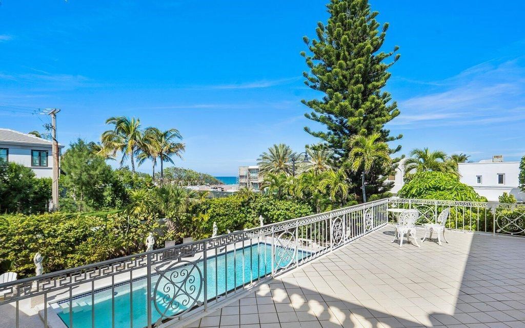 Nestled in Palm Beach's esteemed Estate Section, just moments from Mar-a-Lago, 1048 S Ocean Blvd presents a distinguished John Volk Regency home boasting ocean views and direct beach access.