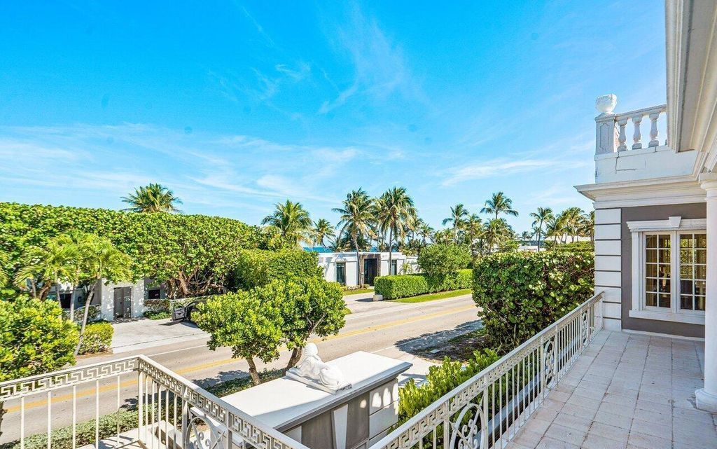 Nestled in Palm Beach's esteemed Estate Section, just moments from Mar-a-Lago, 1048 S Ocean Blvd presents a distinguished John Volk Regency home boasting ocean views and direct beach access.
