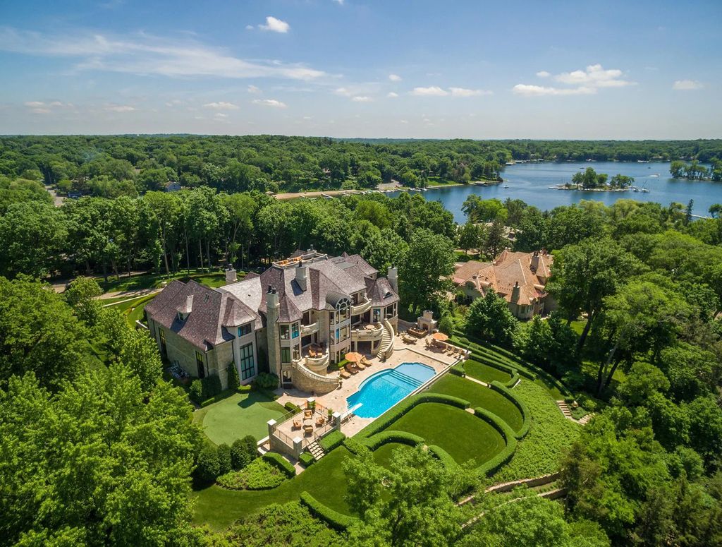 3770 Northome Road Home in Wayzata, Minnesota. Discover the epitome of luxury living on Lake Minnetonka with this John Kraemer & Sons masterpiece. From the luxurious master suite to the state-of-the-art amenities including a bowling alley, golf simulator, and Cavern Music Club, no detail has been overlooked. 
