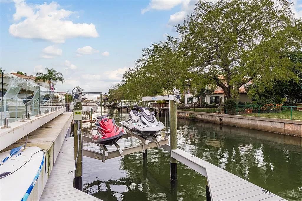 Experience unparalleled luxury waterfront living in this meticulously renovated custom-built Dolphin Home on 100 feet of saltwater frontage in Stoney Point, South Tampa.