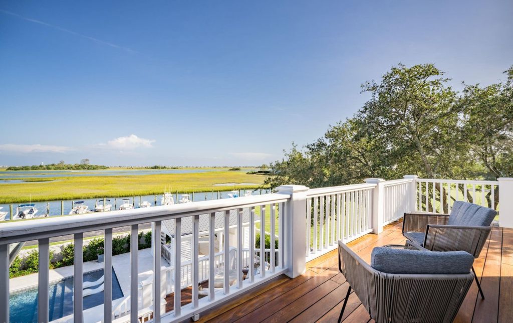 6432 Westport Drive Home in Wilmington, North Carolina. Discover unparalleled coastal living in this extraordinary waterfront estate nestled between Bradley Creek and the Intracoastal in the picturesque Westport community. 