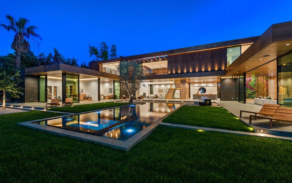 9705 Oak Pass Road Home in Beverly Hills, California. Discover luxury living at its finest in this brand new architectural masterpiece by renowned architect Noah Walker. Situated behind the exclusive gates of Oak Pass Road in Beverly Hills, this ultra private estate features 7 bedrooms, 9 bathrooms, and an array of lavish amenities including a zero edge pool, outdoor kitchen, movie theatre, gym, and more. 