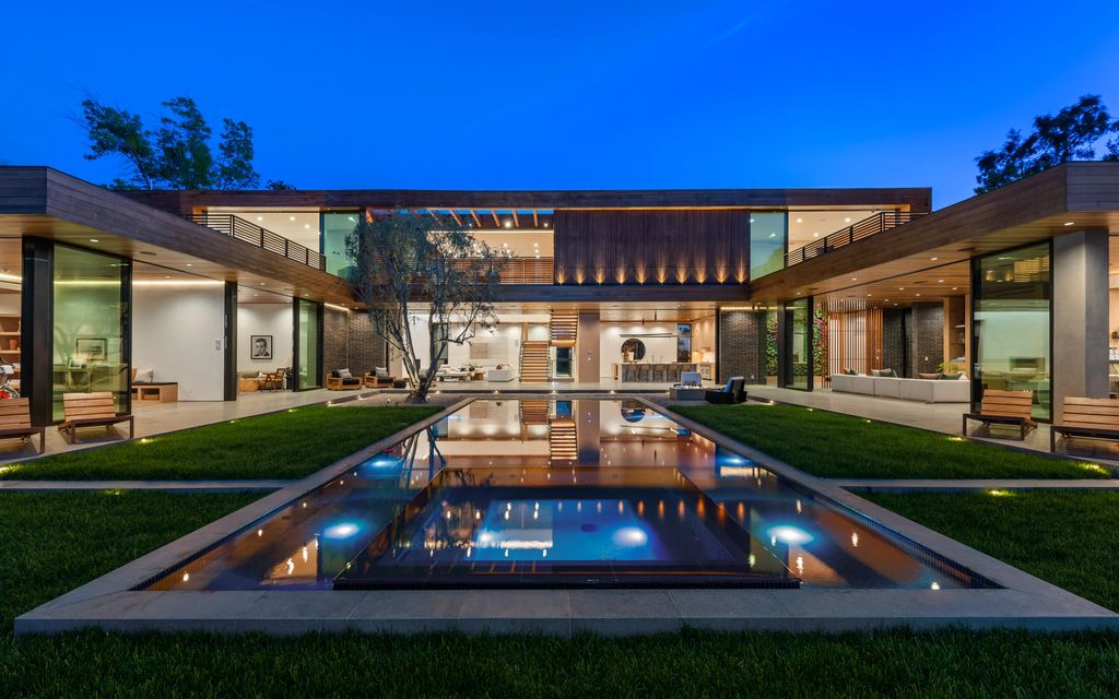 9705 Oak Pass Road Home in Beverly Hills, California. Discover luxury living at its finest in this brand new architectural masterpiece by renowned architect Noah Walker. Situated behind the exclusive gates of Oak Pass Road in Beverly Hills, this ultra private estate features 7 bedrooms, 9 bathrooms, and an array of lavish amenities including a zero edge pool, outdoor kitchen, movie theatre, gym, and more. 