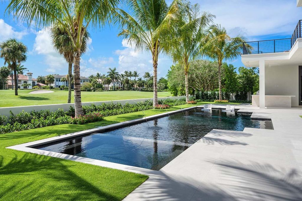 This prestigious Signature Estate within the Royal Palm Yacht & Country Club offers breathtaking views of lush golf course fairways.