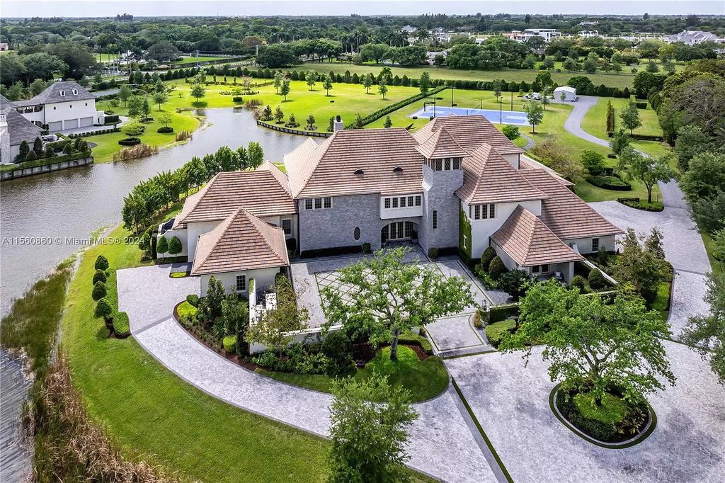 Indulge in the pinnacle of luxury with this custom French Country style mansion in Southwest Ranches, boasting over 15,000 square feet of meticulously crafted living space.